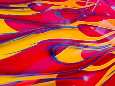 Bright abstract texture photo of red and yellow flowing shapes with blue accents, vibrant macro art by Bernd Meyer